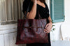 Handmade red leather bag with black wash and rivet belt