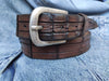 Brown leather belt with handmade cuts in the shape and texture of a crocodile