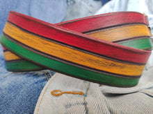 Leather belt designed in African colors, red, yellow and green with a brown wash and belt tail with a crocodile texture