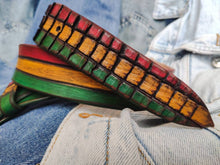 Leather belt designed in African colors, red, yellow and green with a brown wash and belt tail with a crocodile texture