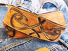 A brown leather belt with tribal that made from ishaor logo and vintage finish that give to the belt western rodeo style