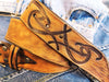 A brown leather belt with tribal that made from ishaor logo and vintage finish that give to the belt western rodeo style