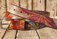 Handmade Leather Belt with Turquoise, Purple & Orange Floral Carvings on White Background with Black Wash - 3.2cm